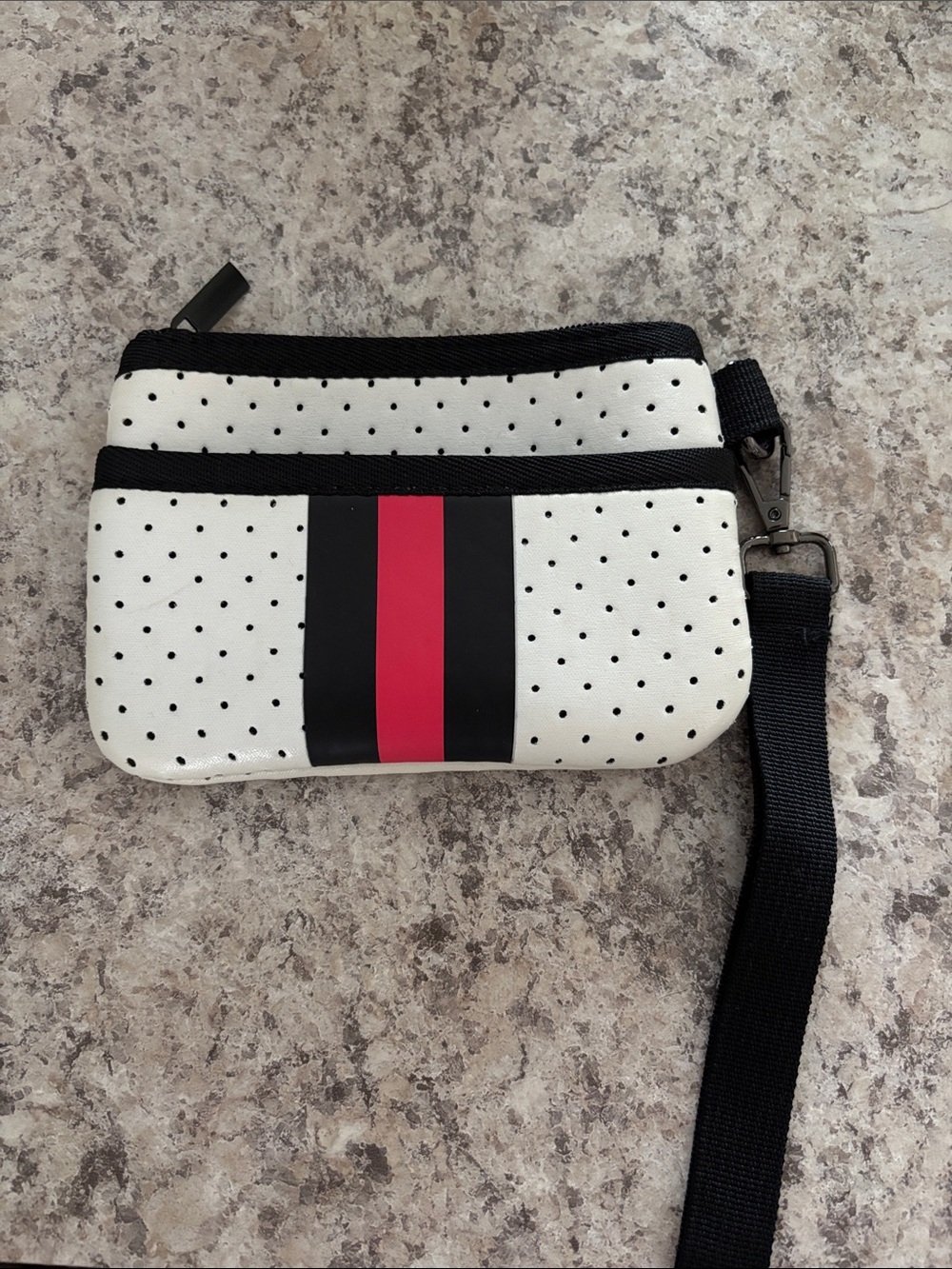 Perforated White Wristlet with Black and Pink Center Stripe